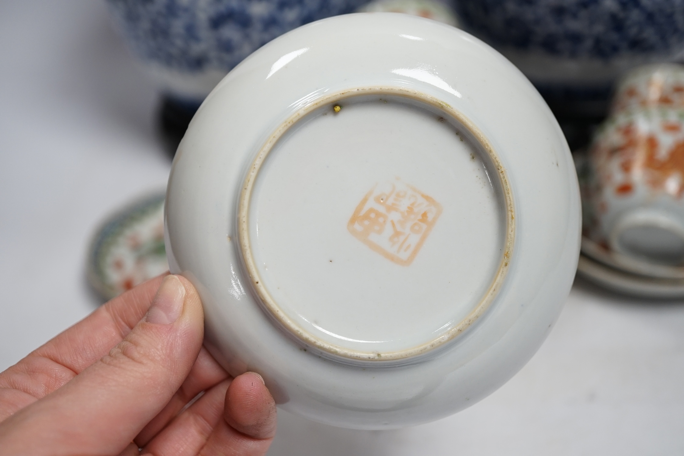 A pair of Chinese blue and white barrel jars, various cups and saucers and three hardwood stands, largest 21cm high